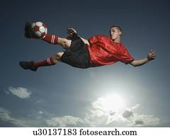 Low angle view of soccer player jumping