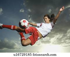 Low angle view of soccer player jumping