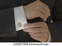 Close up of businessman wearing dollar sign cuff link
