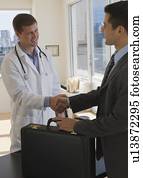 Doctor and businessman shaking hands