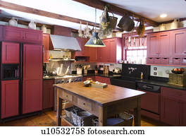 Kitchen in colonial house with red cabinets
