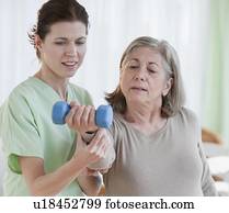 Physical therapist helping senior woman