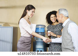 Casual meeting by office water cooler
