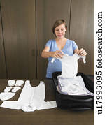 Pregnant woman packing maternity bag