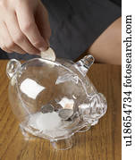 Person Saving Money in Piggy Bank