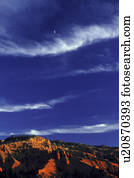 Bands of cloud above rocky desert terrain
