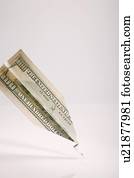 One hundred American dollar bill folded into paper airplane