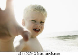 Boy reaching out to camera