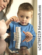 mum and son and money pile