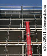 View up scaffolding with red rubble chute prominent