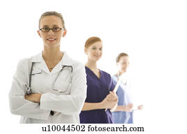 Portrait of smiling Caucasian medical healthcare workers in uniforms standing against white background.