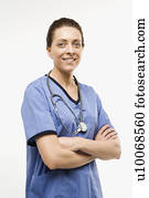 Portrait of smiling Caucasian woman doctor standing against white background.