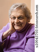 Elderly Caucasian woman smiling with hand on face. Elderly Caucasian woman smiling with hand on face.
