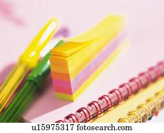 Colorful sticky and pens on notebook