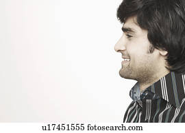 Side profile of a young man smiling Stock Photo | u18923368 | Fotosearch