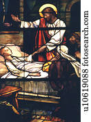 Jesus healing a sick child depicted on stained glass